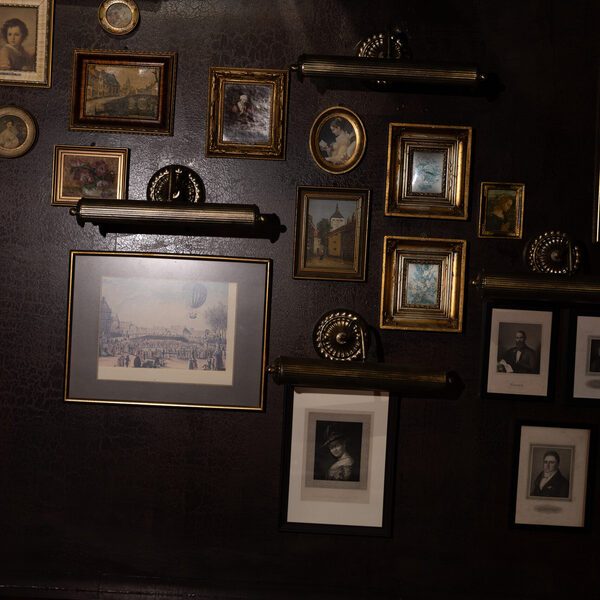 The wall of gilded frames and prints